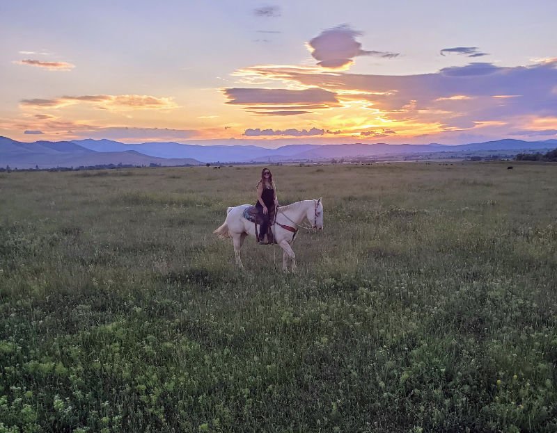 Female on horse at sunset
